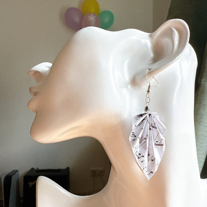 Lightweight origami leaf earrings featuring music notes