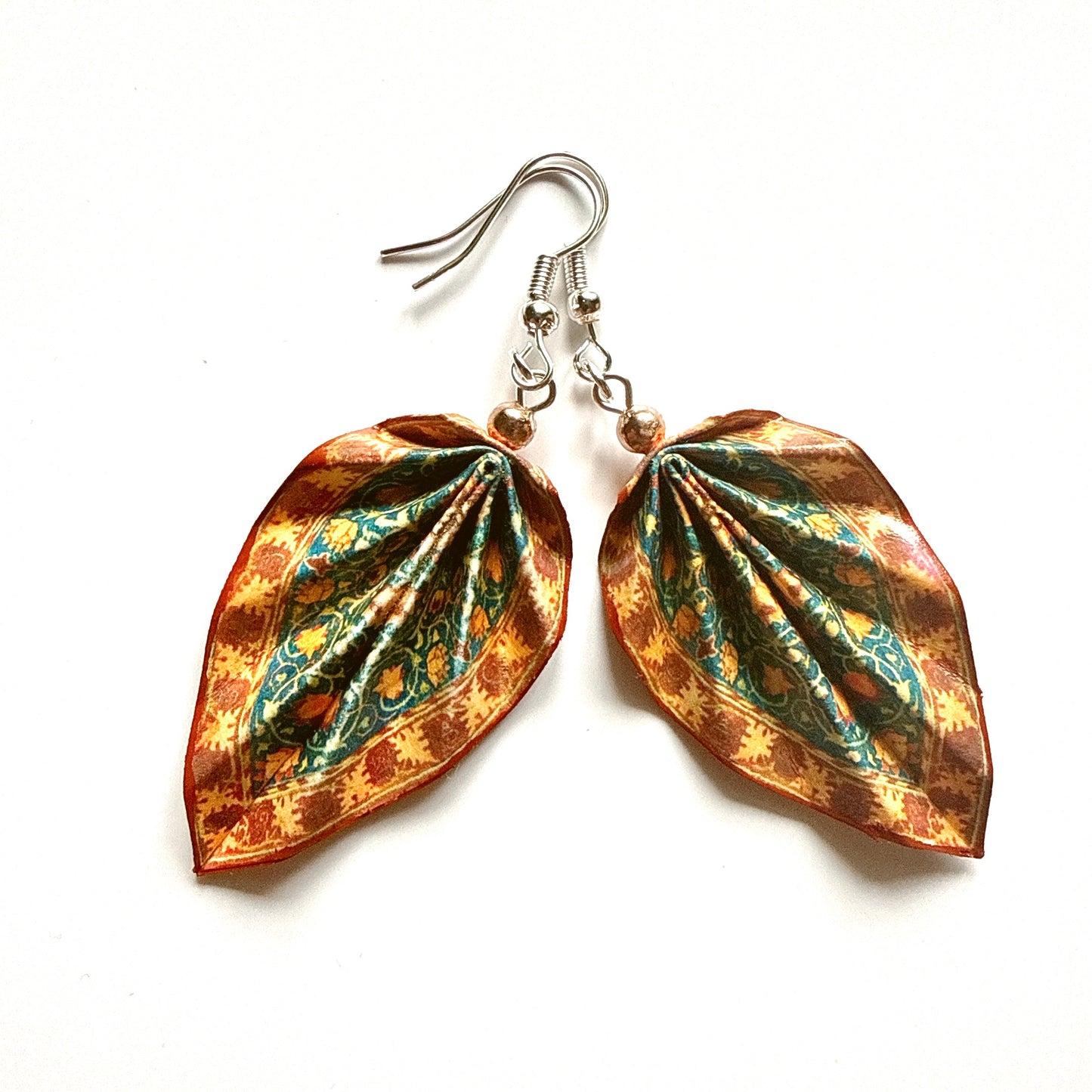 Leaf-shaped earrings with floral pattern on a white background