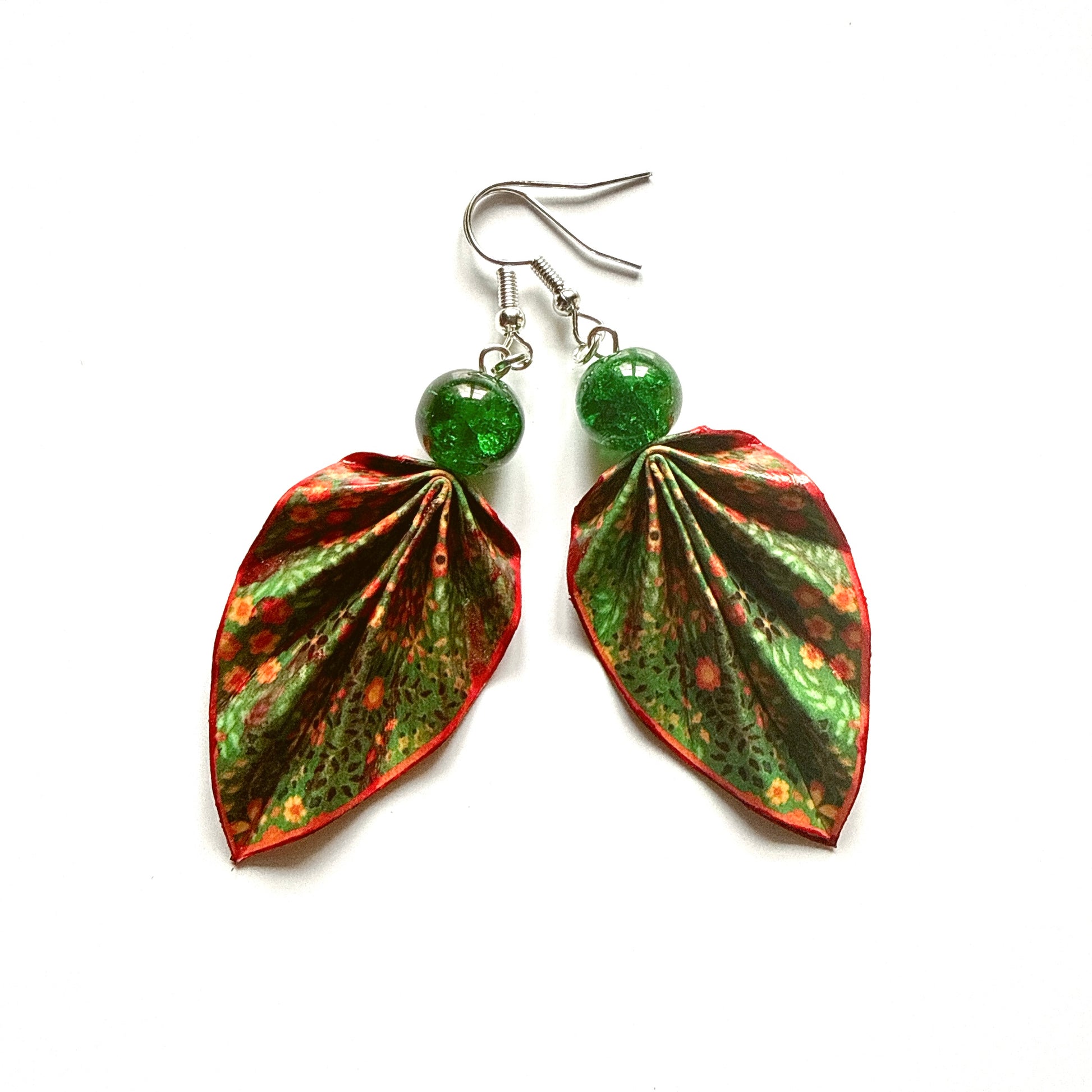 Leaf-shaped earrings with green and red patterns on a white background