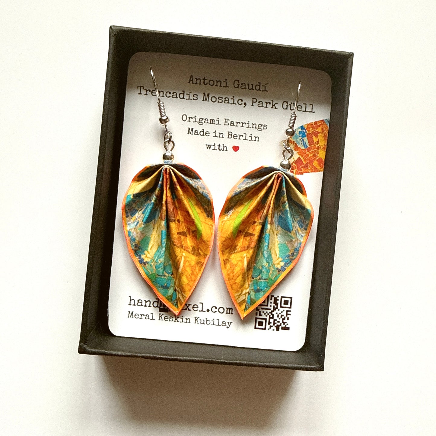 Pair of origami earrings in a box with a label