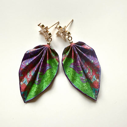 Pair of colorful leaf-shaped earrings on a white background
