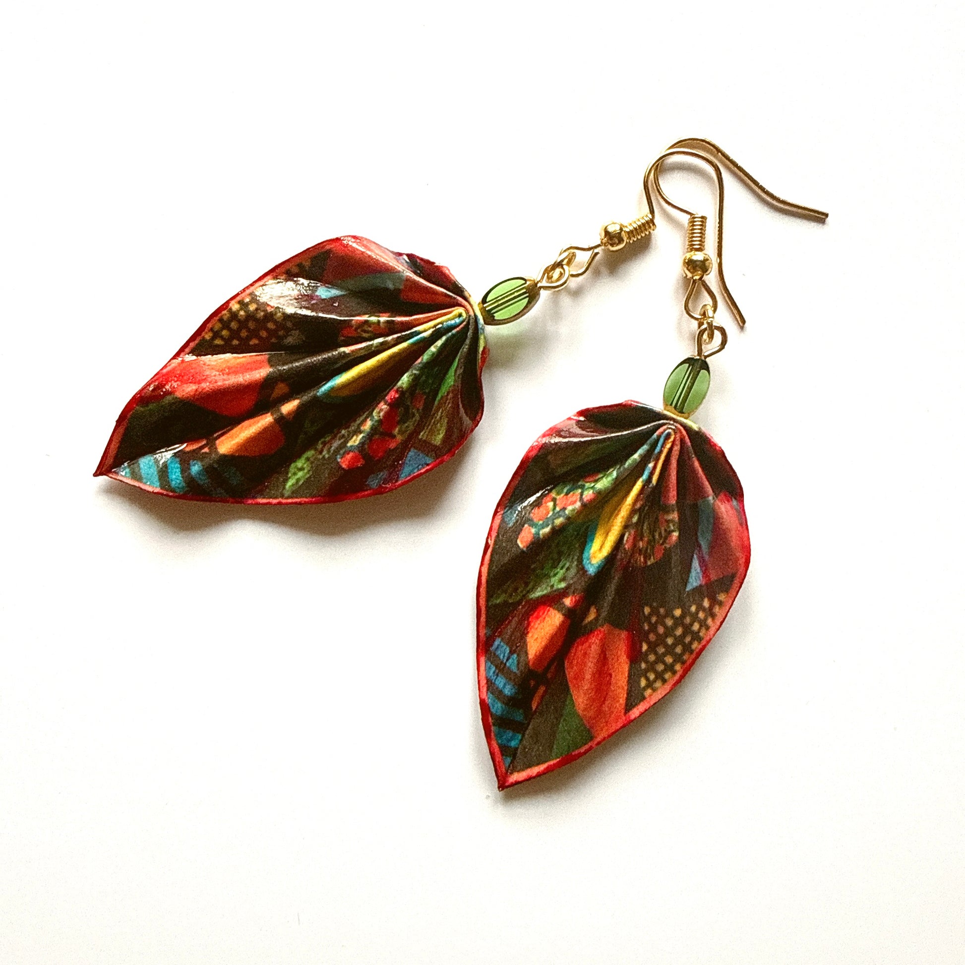 Leaf-shaped earrings with colorful patterns on a white background