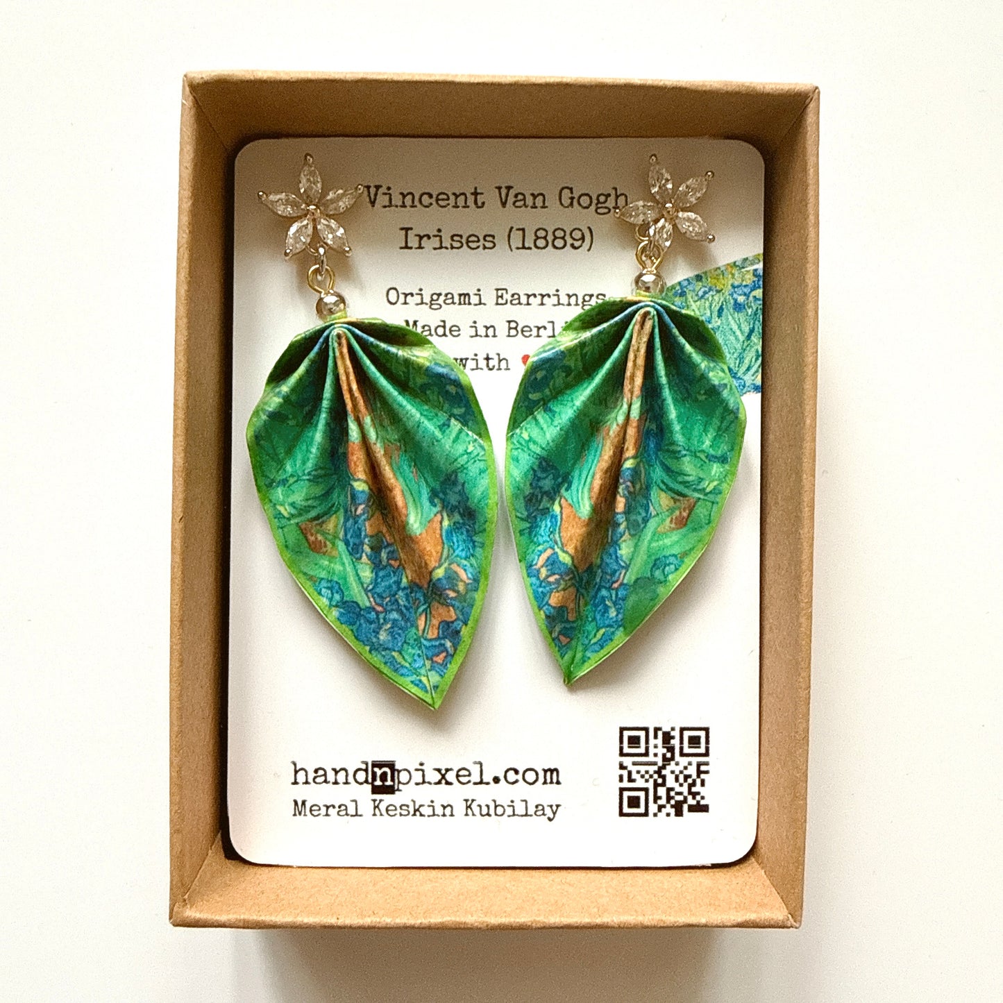 Pair of origami earrings in a box with a label