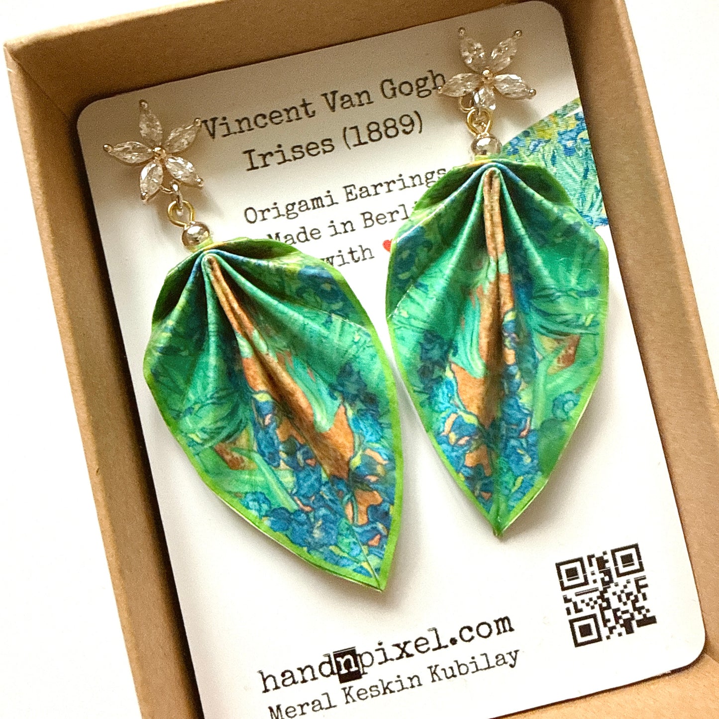 Origami earrings with floral design on a branded card