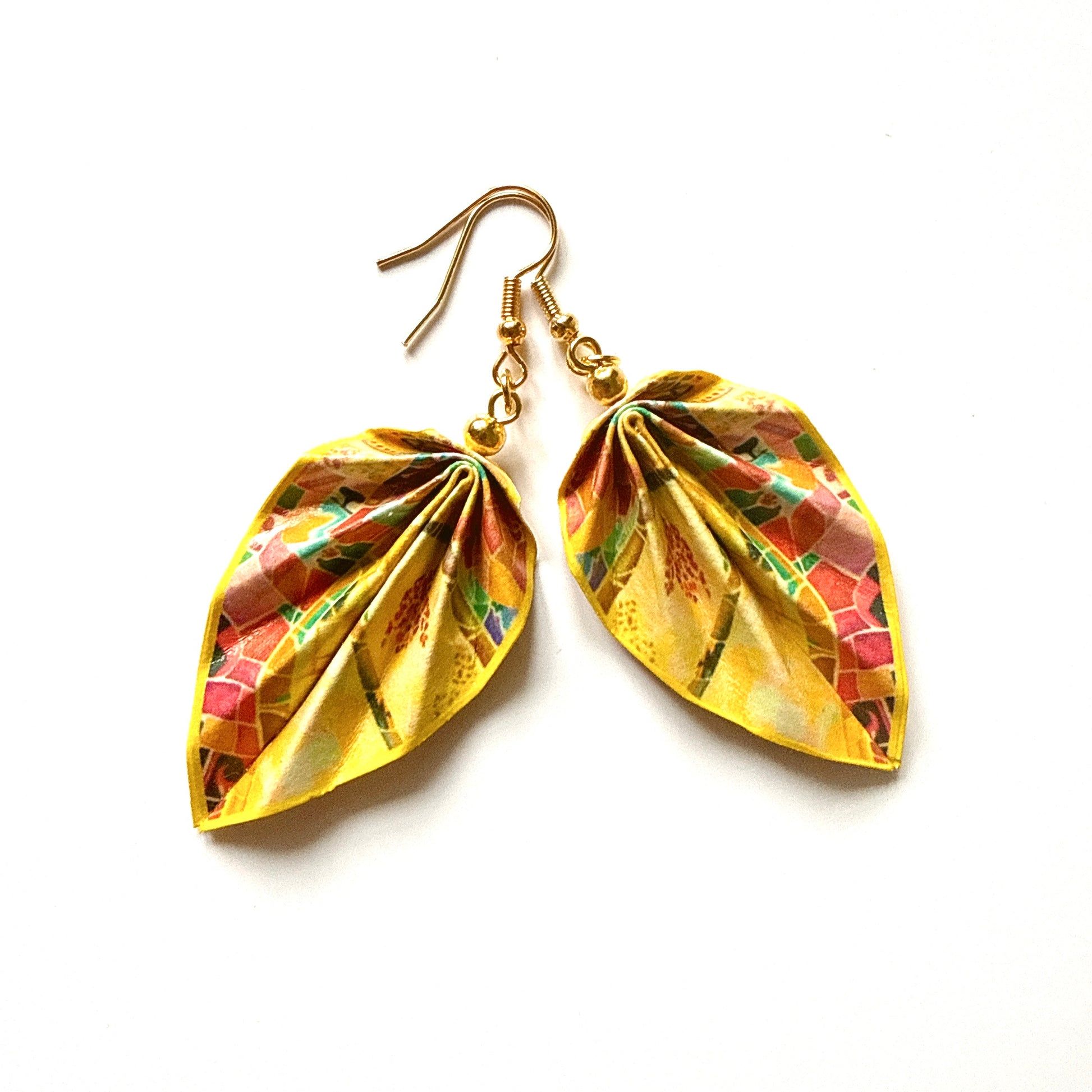Gold leaf-shaped earrings with colorful mosaic design on a white background
