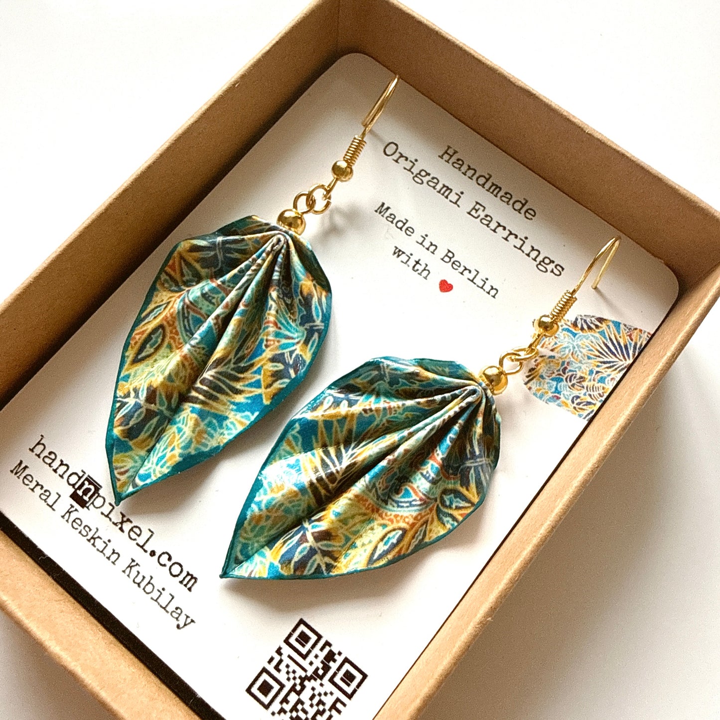 Handmade origami earrings in a box with a label