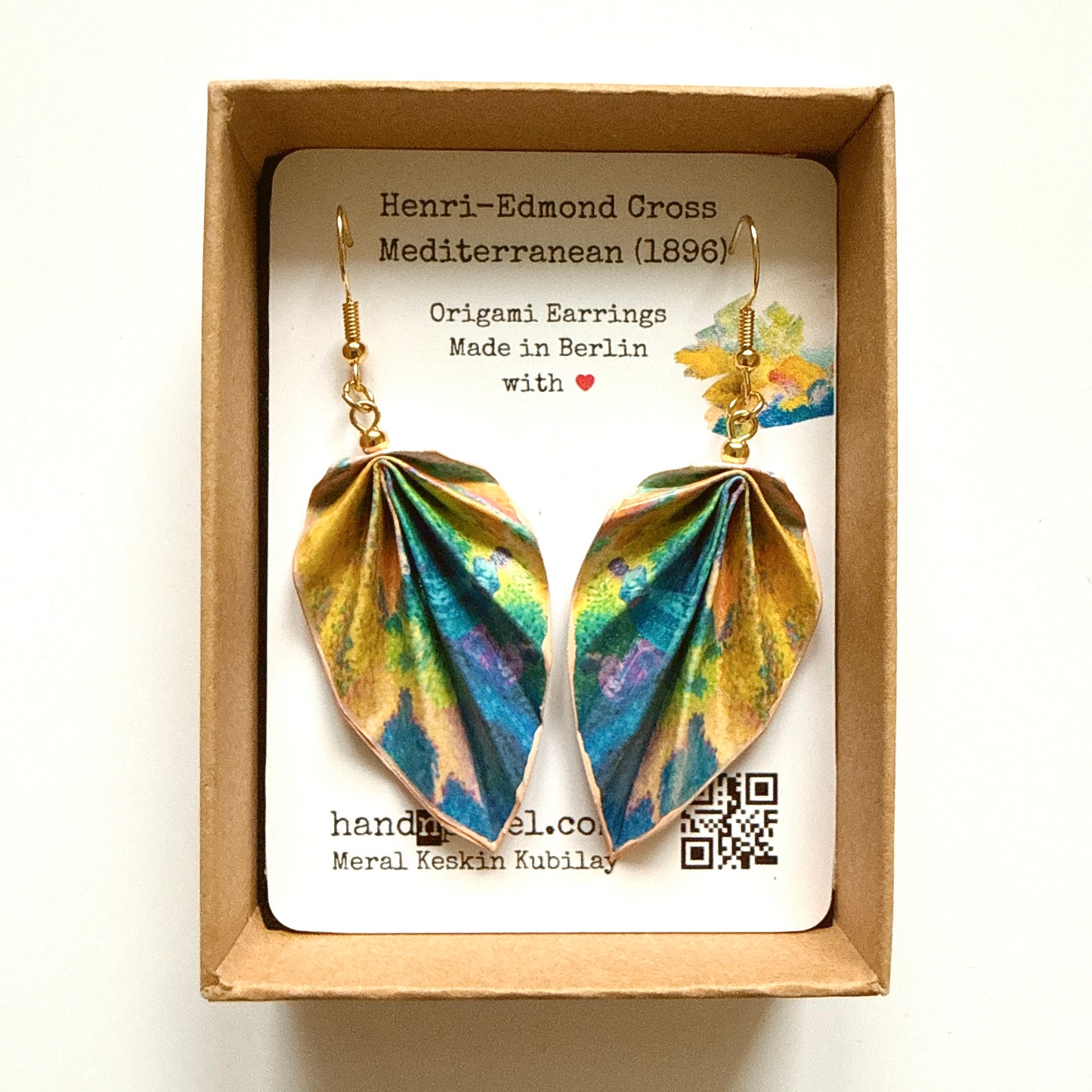 Pair of origami earrings in a box with a label