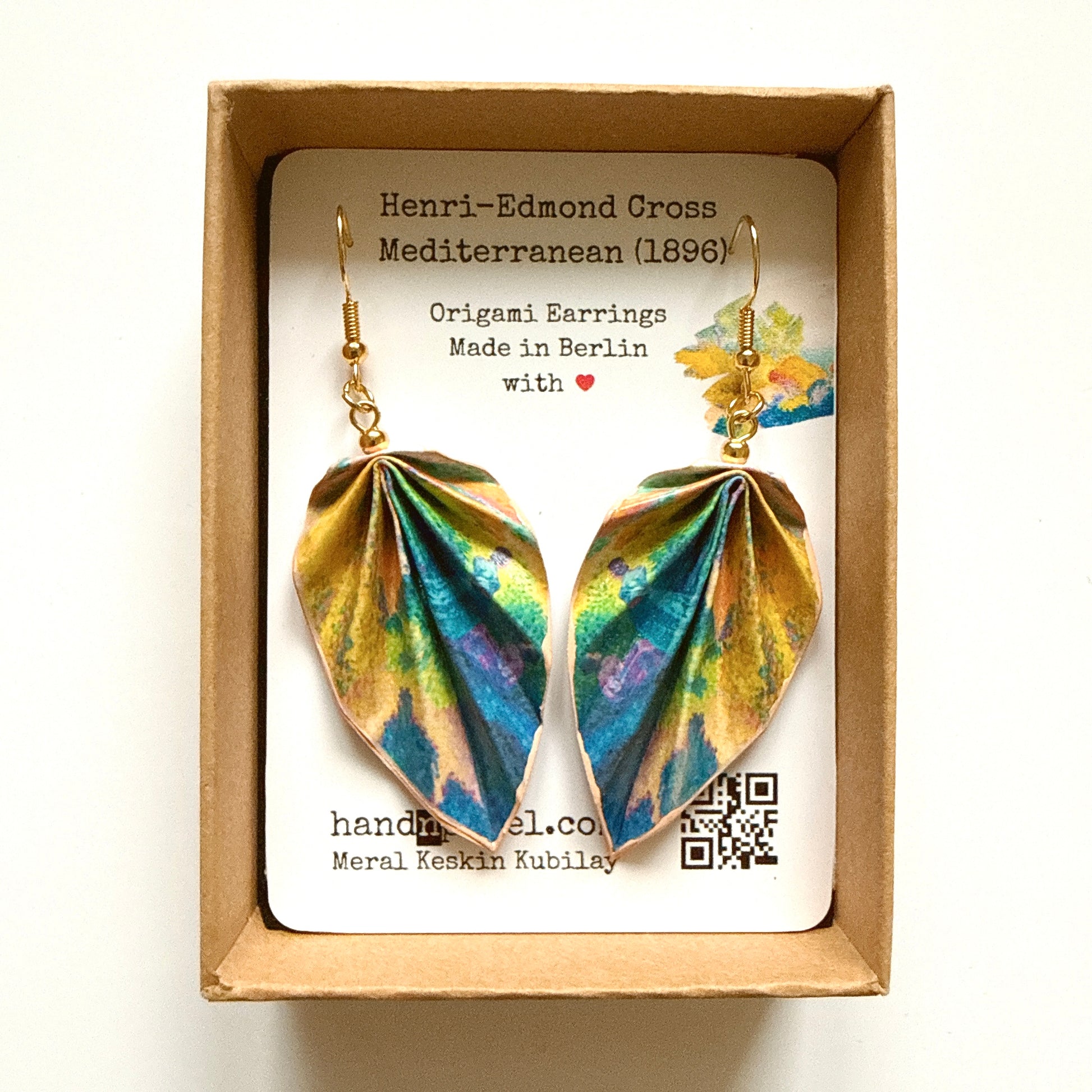 Pair of origami earrings in a box with a label