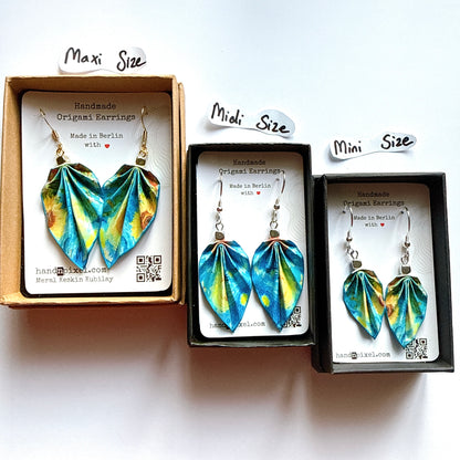 Three boxes of origami-style earrings with size labels on a white background