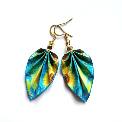 Pair of colorful leaf-shaped earrings on a white background