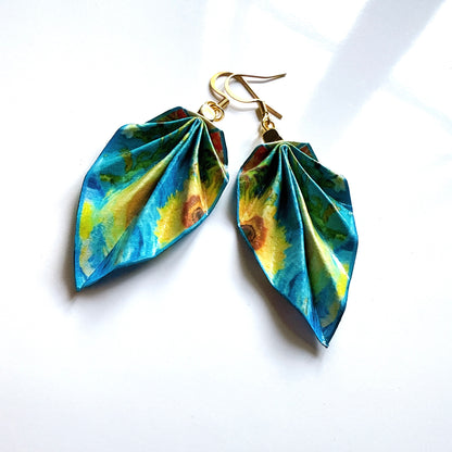 Pair of blue and green leaf-shaped earrings on a white background